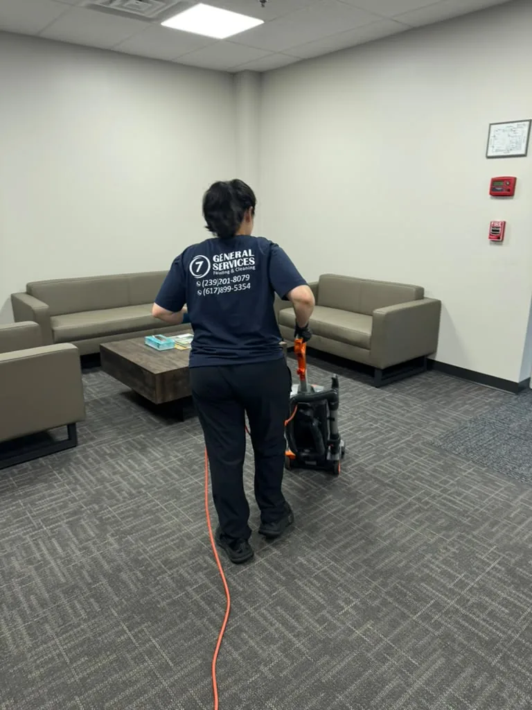 7 General Services vacuuming an office lounge carpet in Greater Boston, MA