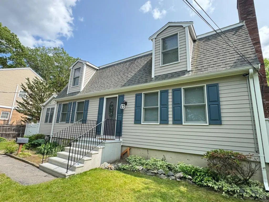 Freshly painted home exterior with lawn in Greater Boston, MA