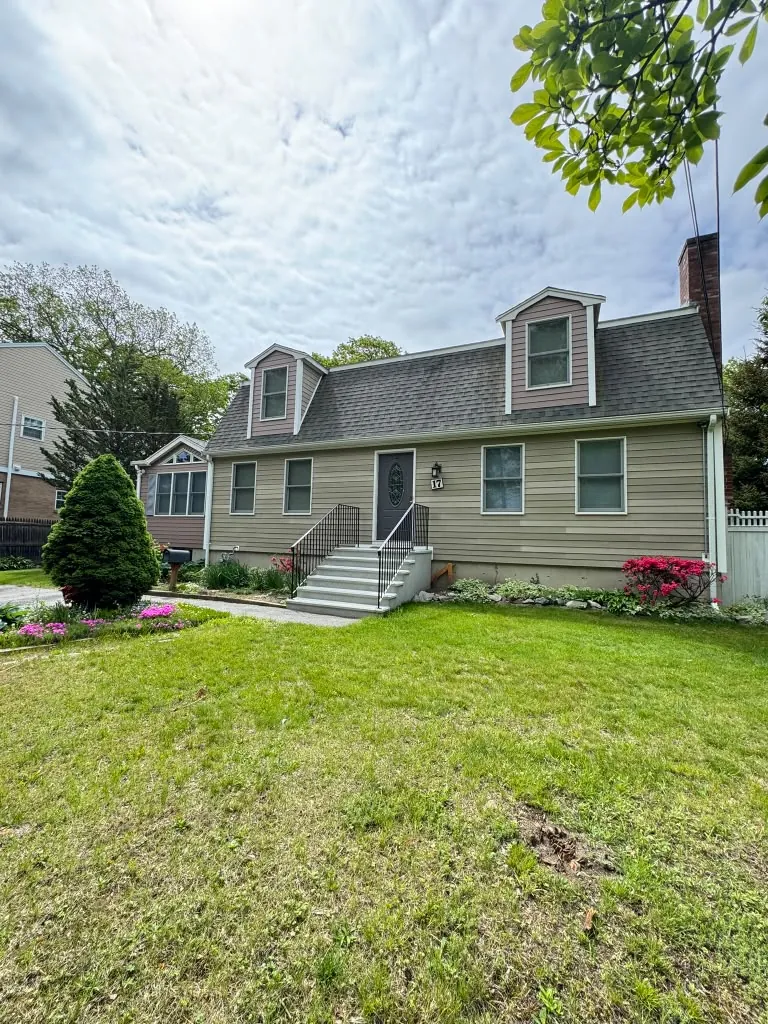 Repainted home exterior with lawn in Greater Boston, MA