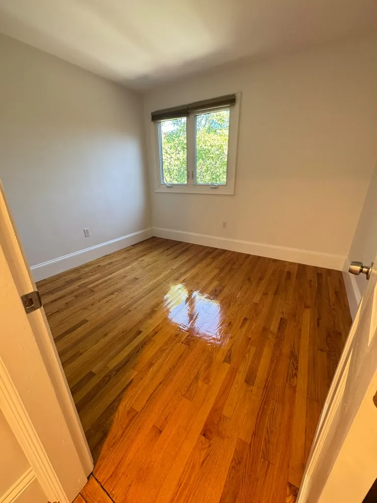 Spotless empty room with hardwood floor after cleaning, Greater Boston MA